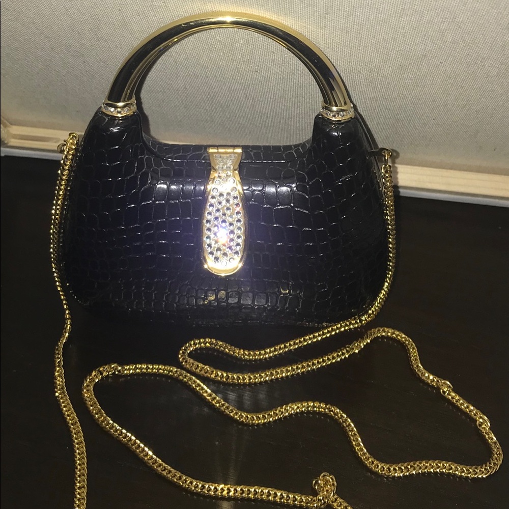 Women’s black and gold mini hard cover purse